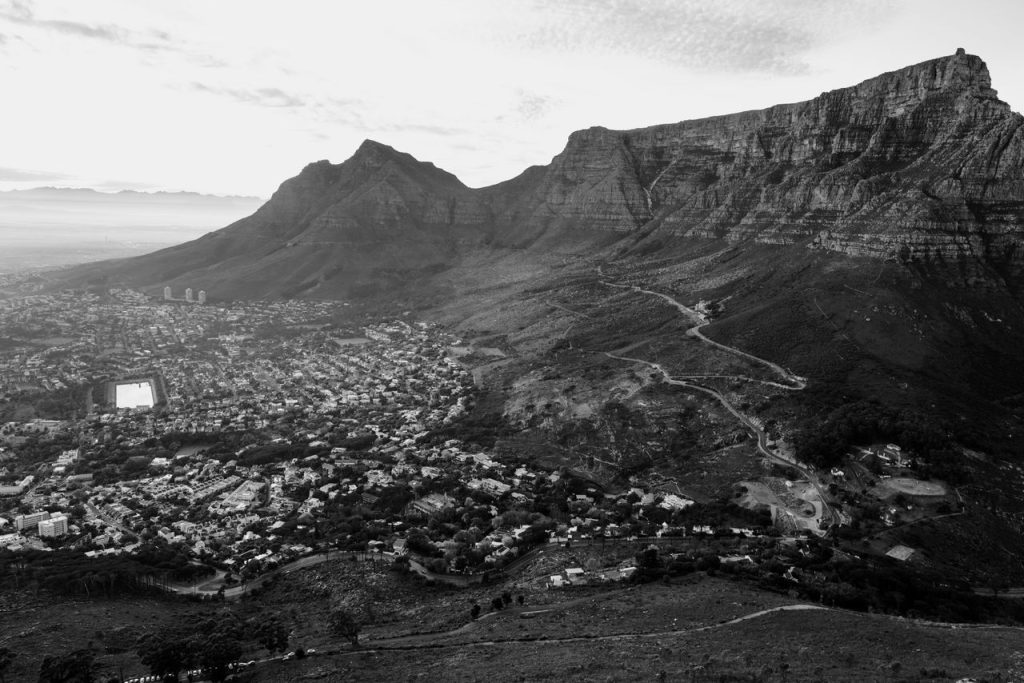 Aerial black and white view of Cape Town's cityscape with the iconic Table Mountain.
